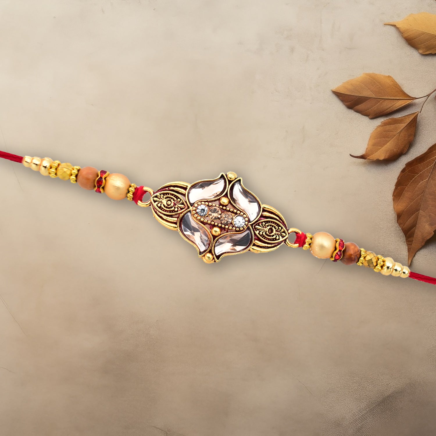 Elegant Floral Designer Rakhi With Gold-toned Beads  Red Thread Elegant Floral Designer Rakhi With Gold-toned Beads  Red Thread
